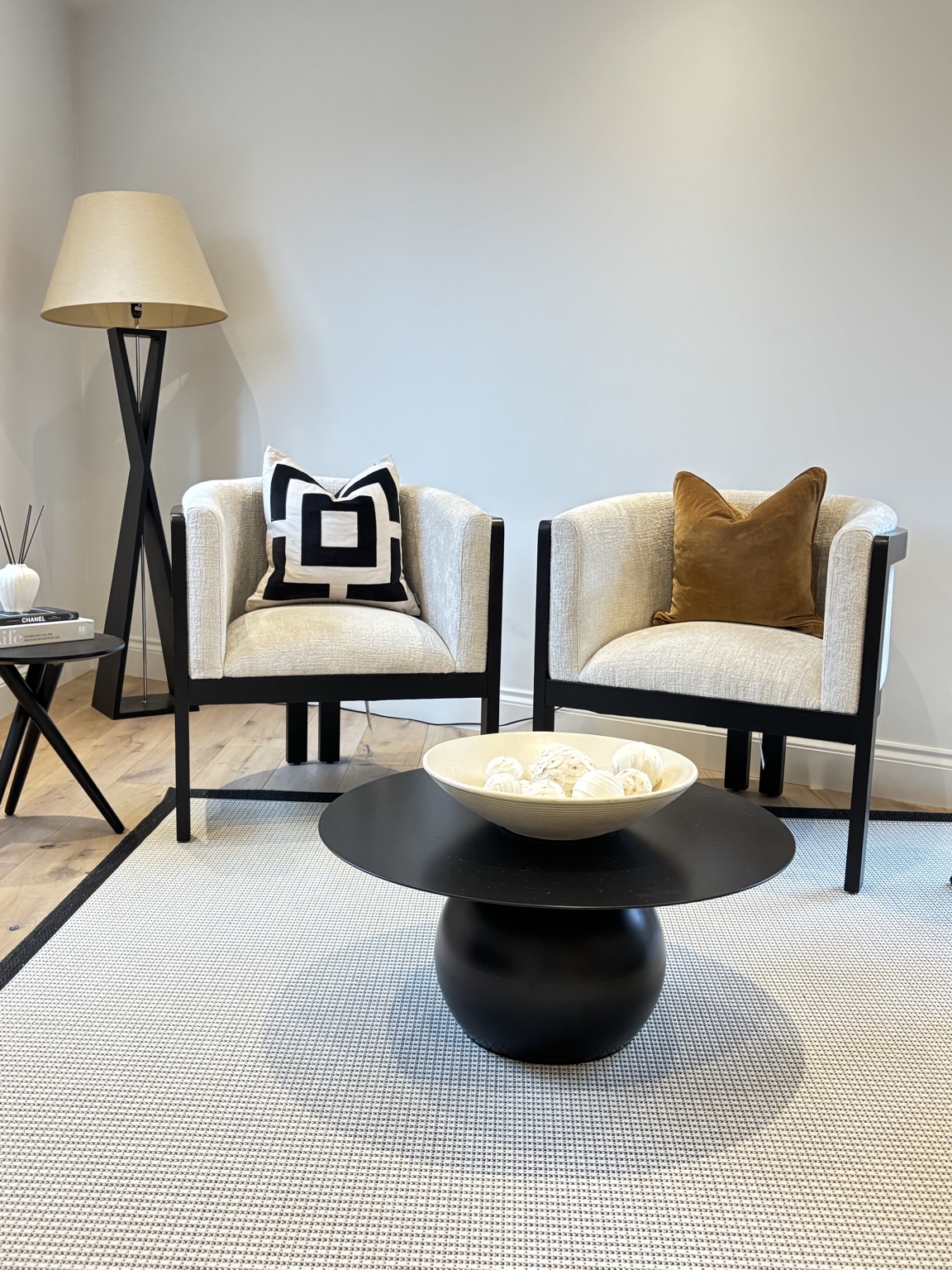 Staged living room with two chairs and a coffee table